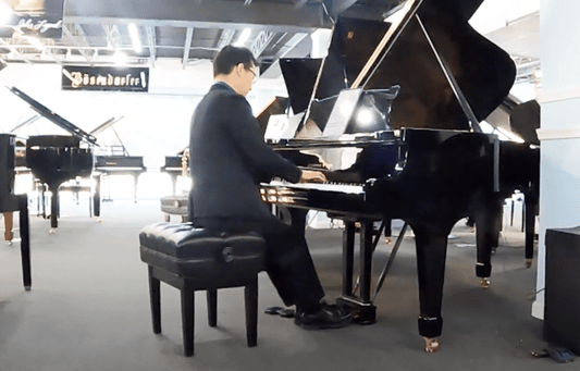 Man in black dress playing Piano